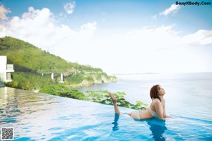 A woman in a bikini standing in the water.