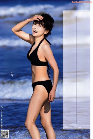 A woman in a white bikini posing for a picture.