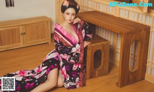 A woman in a kimono is posing for a picture.