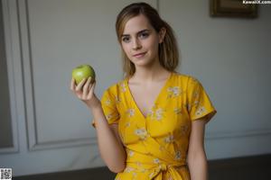 A woman sitting on a blue couch holding a can of soda.