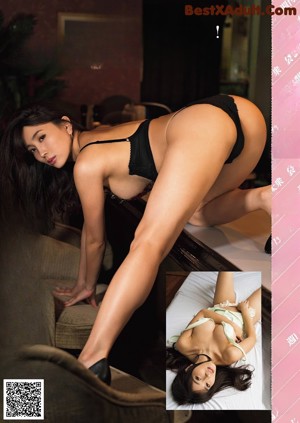 A woman in a pink lingerie sitting on a brown couch.